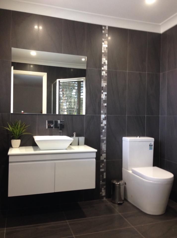 Charcoal-tiled ensuite with floating vanity